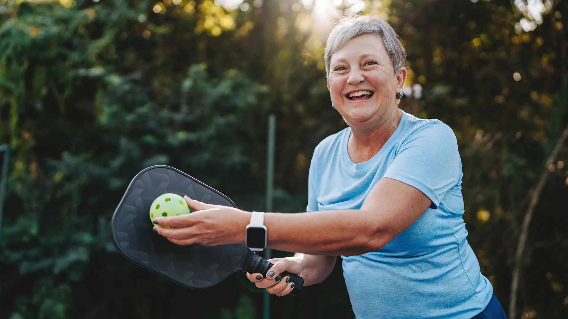 Happy woman playing pickleball