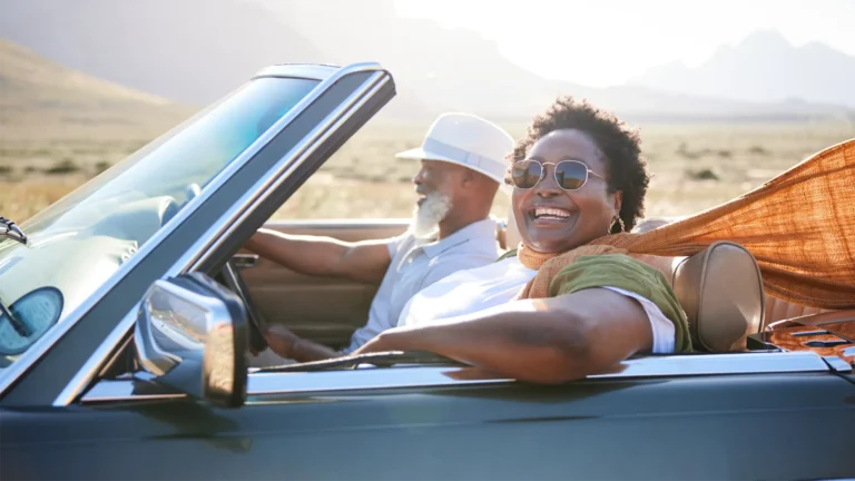 Woman in sunglasses riding in a car in the desert